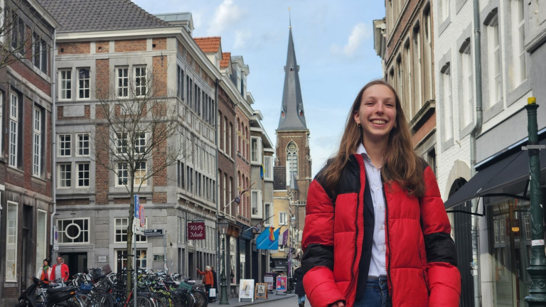 Girl with a red and black puffer jacket in the area of Wyck, Maastricht