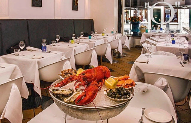 Restaurant, seafood, lobster, ice bucket, table setting with white table cloths, wine glasses on the table