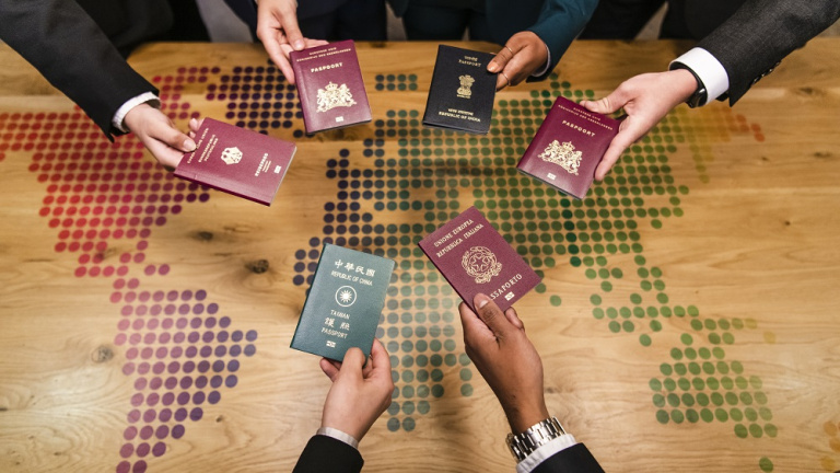 Student stands in front of the smart board in the classroom and gives presentation to his fellow students at the hotel school maastricht.