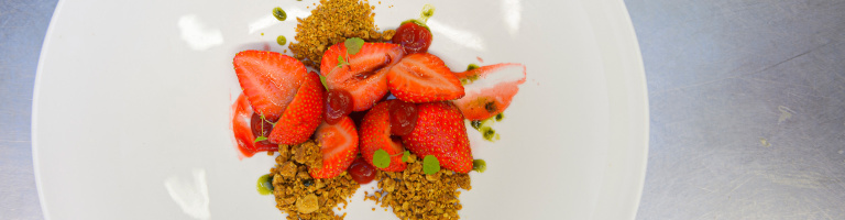 Een dessert van verse aardbeien klaar om geserveerd te worden in het restaurant van Teaching Hotel Château Bethlehem.